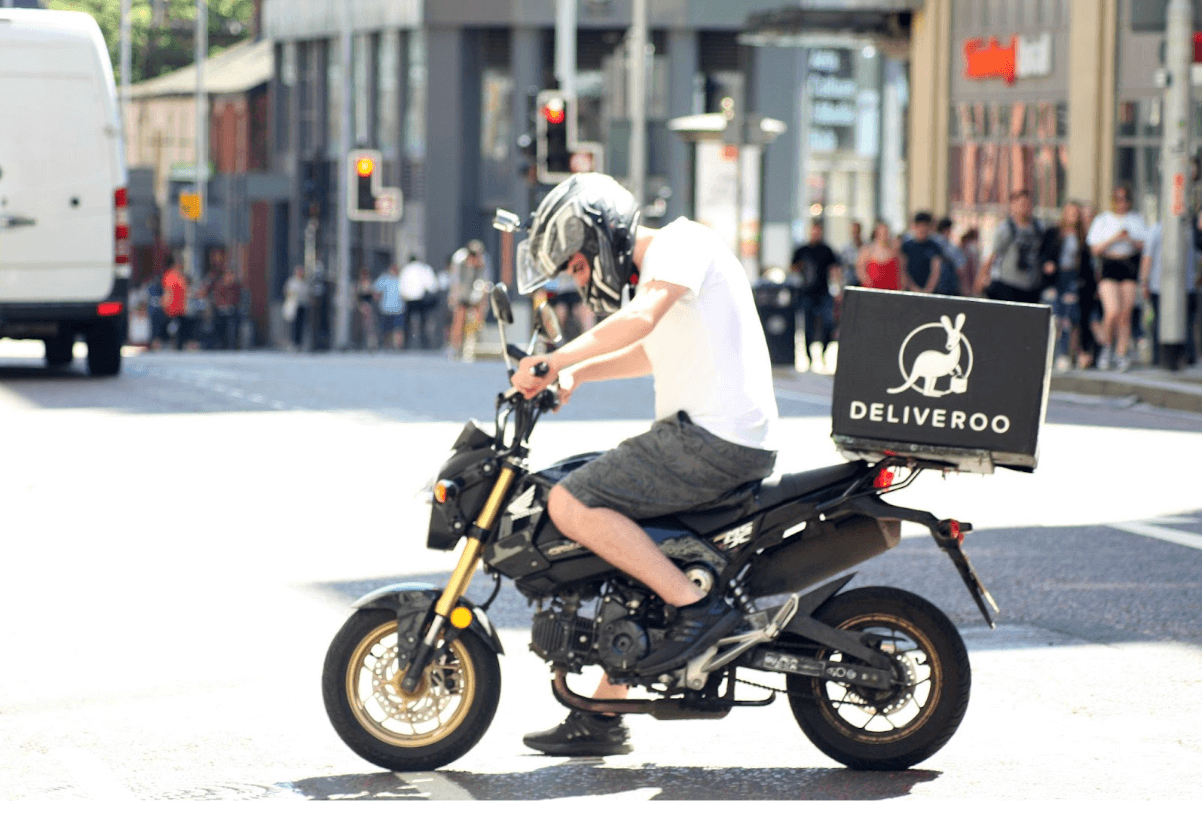 a Deliveroo delivery partner on a motorcycle